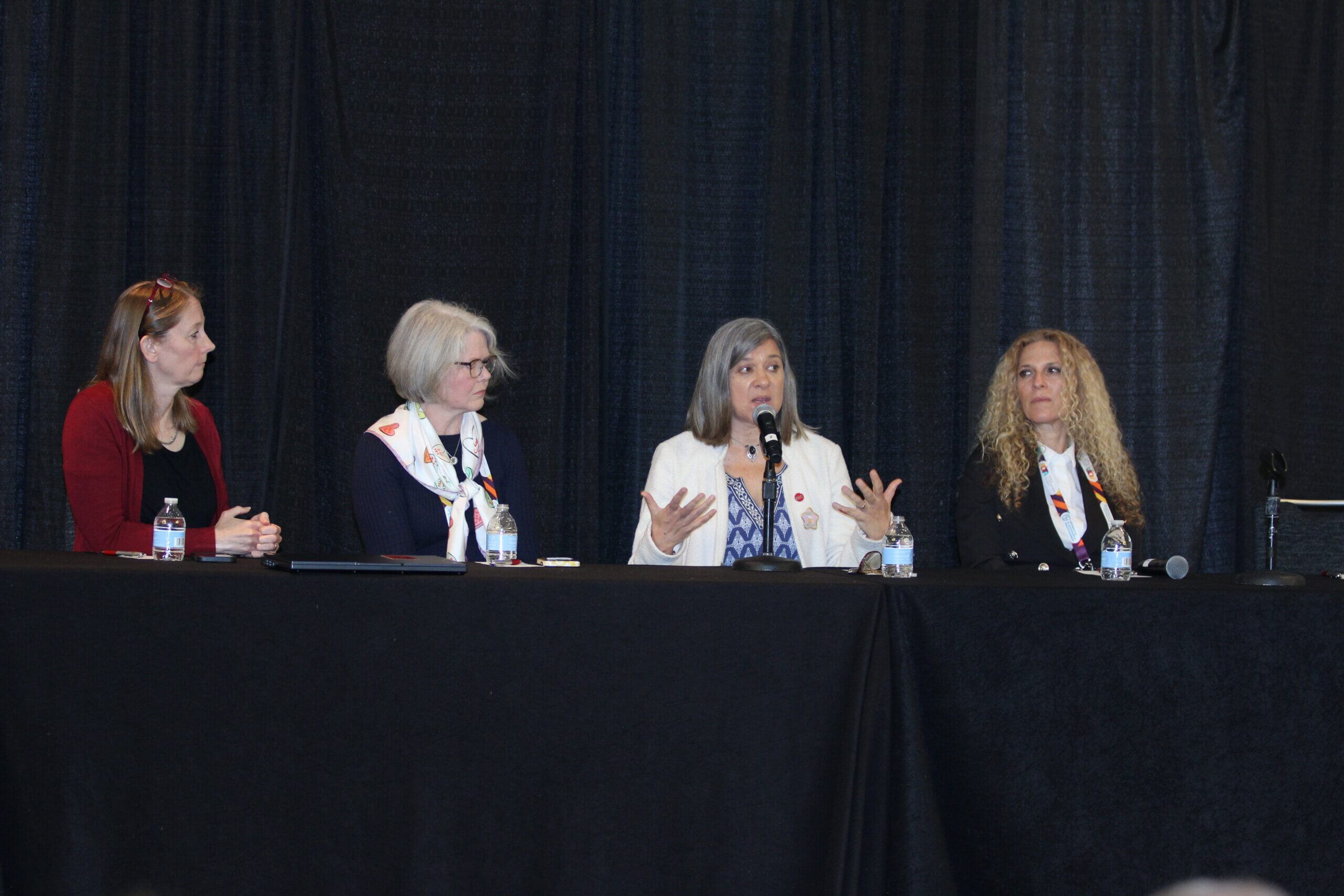 A group of 4 women speaking in a panel discussion during the 2025 AOTF Academy of Research Symposium during the 2025 AOTA INSPIRE Conference & Expo.